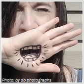 young woman with mouth drawn on hand